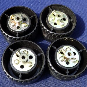 Four Meccano plastic road wheels, part 187c, with iridescent bush wheels, ect.