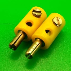 Two Meccano miniature Screw plugs, yellow.