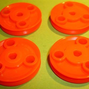 Four Meccano tri-axle plastic pulleys, part 22CP3P, orange