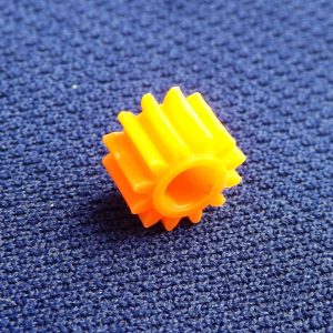 Meccano plastic tri-axle pinion 12 teeth ¼", part 25bp3p, in various colours.